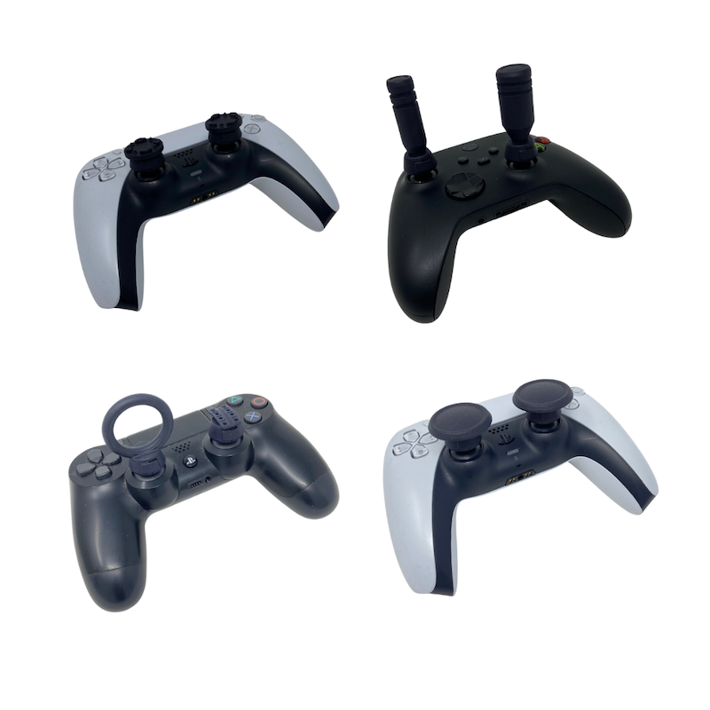 Four different shapes of gaming controller joystick extenders. Some make the joysticks wider, some taller, and one creates an upright O-ring.