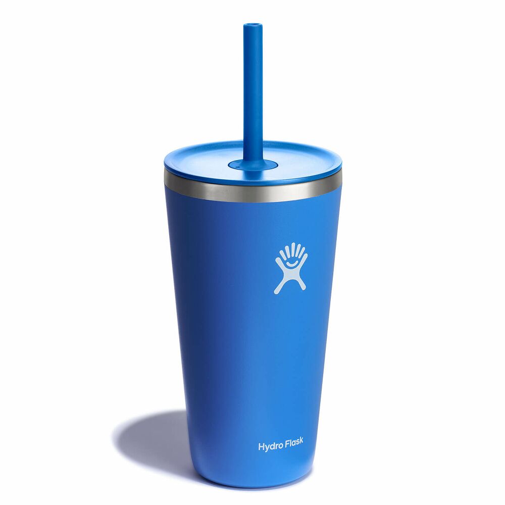 A blue Hydroflask tumbler with a lid and straw over a white background.