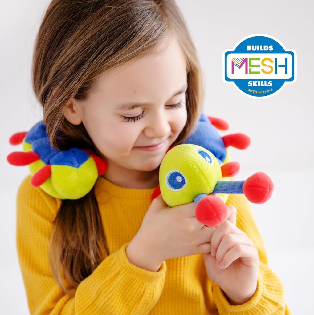 A young girl with a weighted soft stuffed caterpillar around her shoulders looks down at its face.